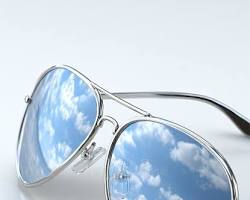 Luxury sunglasses reflection - Summer fashion essentials from The Elite Collective.