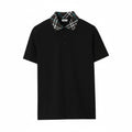 Close-up of the Burberry check pattern on a black pique polo shirt collar.