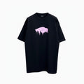 Model wearing an oversized black Balenciaga t-shirt with a glossy pink wet brush logo.
