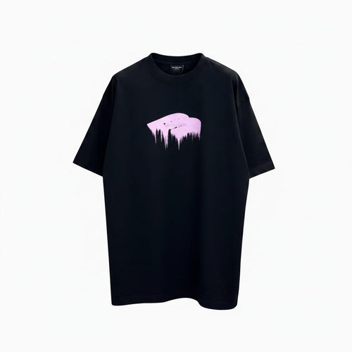 Model wearing an oversized black Balenciaga t-shirt with a glossy pink wet brush logo.