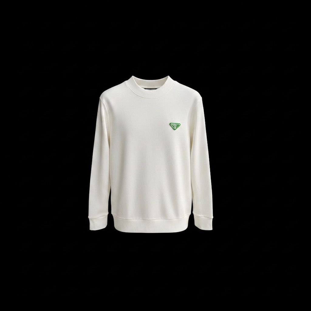Model wearing a cream Prada crewneck sweatshirt with a green triangle logo on a European street.