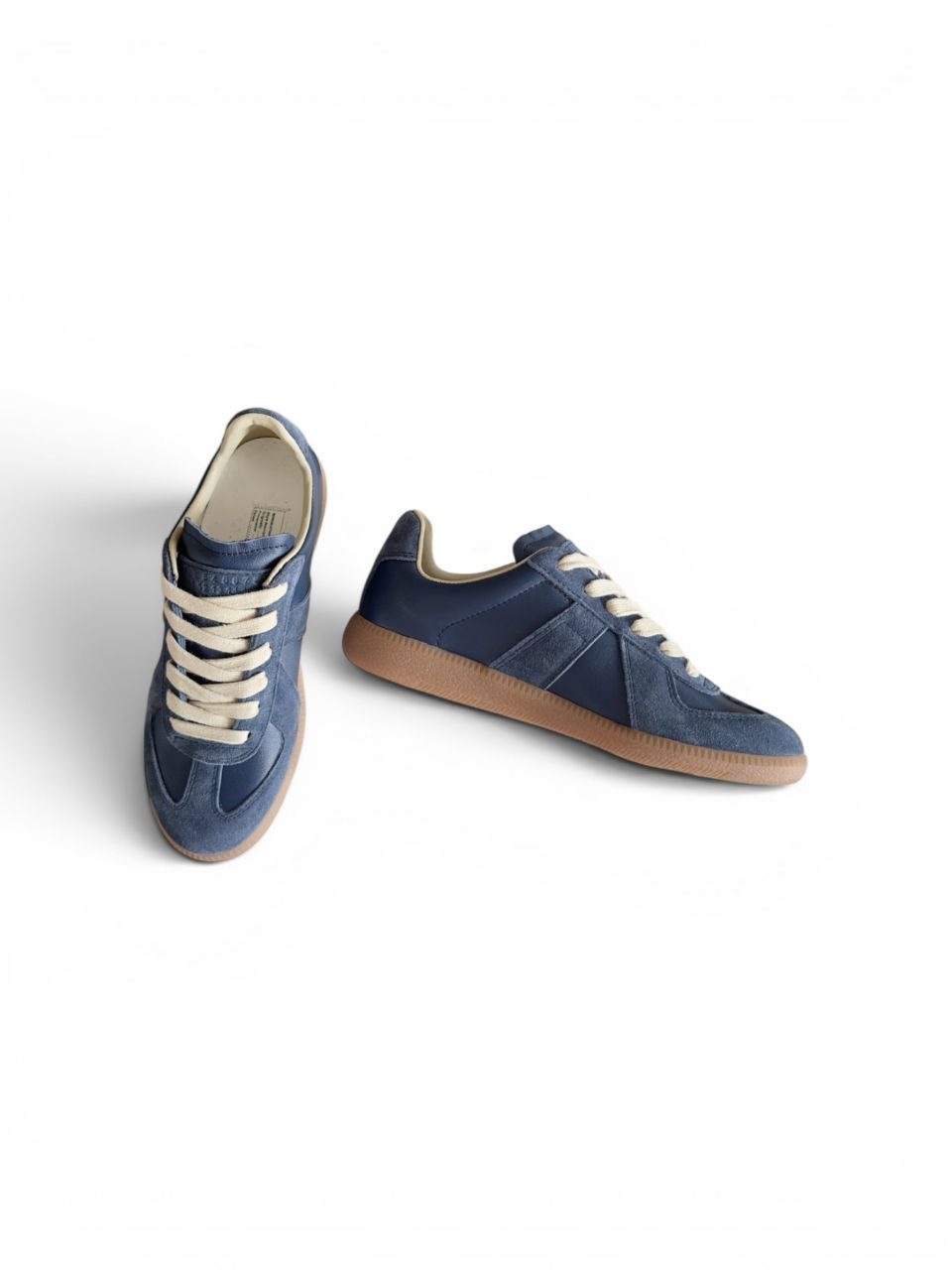 Maison Margiela Replica sneakers in navy blue leather and suede with a gum sole.