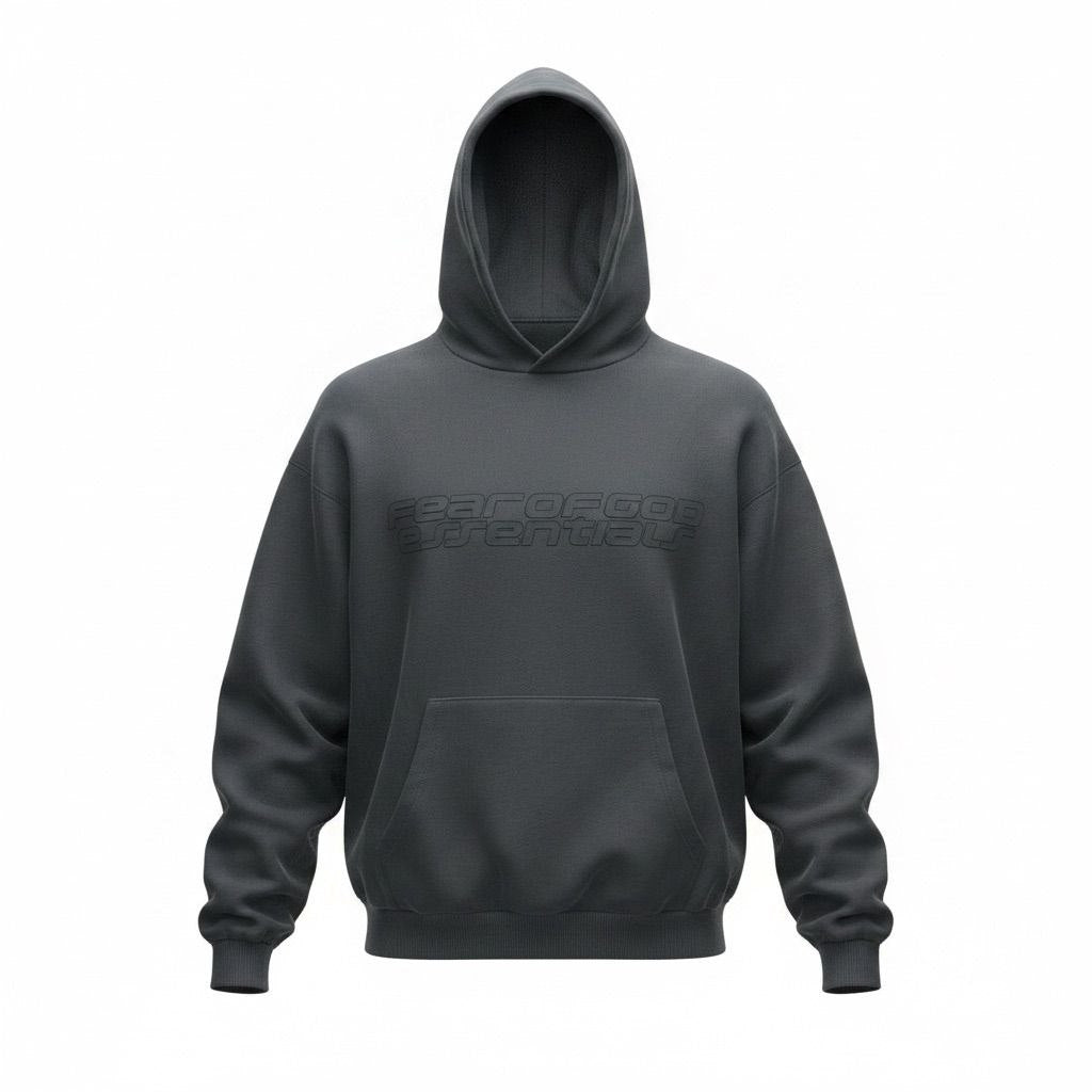 Model wearing an oversized dark grey Fear of God Essentials 90s hoodie.