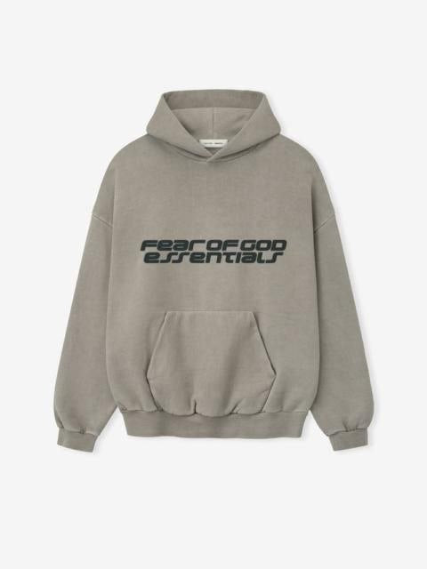 Model wearing an oversized taupe Fear of God Essentials 90s hoodie.