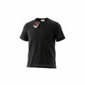 Model standing in a garden wearing a black Gucci t-shirt with a tonal Interlocking G logo on the chest.