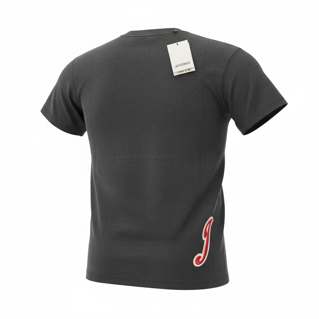 Back view of a black Jacquemus t-shirt showing the red script 'J' logo on the bottom right hip.