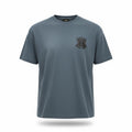 Close-up of the black and white MA monogram logo on a blue Amiri cotton t-shirt.