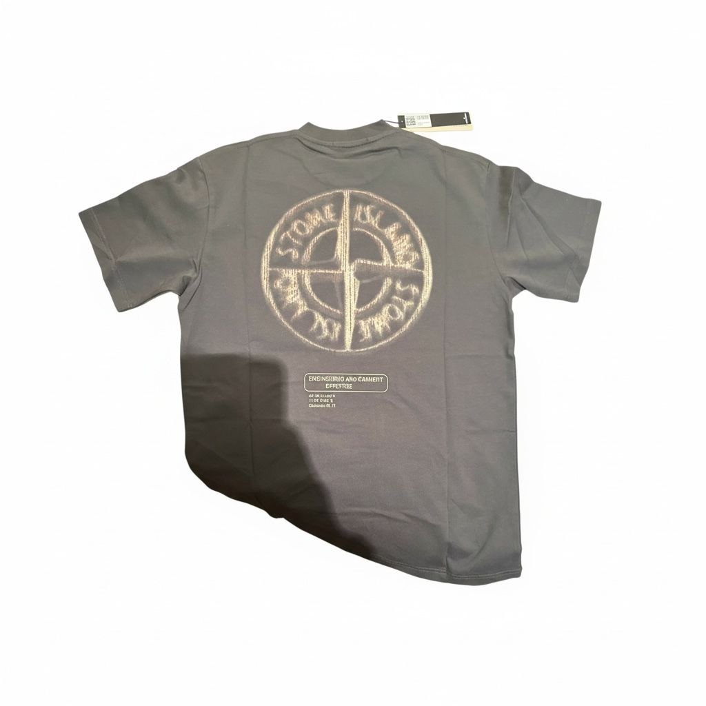 Back view of a charcoal Stone Island t-shirt with a large white compass logo and engineering text.